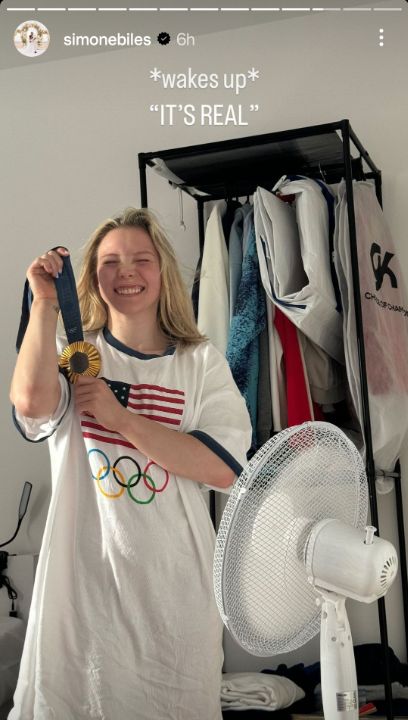 Jade Carey displays her gold medal in pajamas.