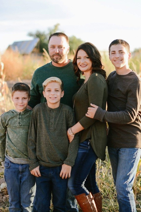 Tyler Robinson with his parents and two younger brothers.